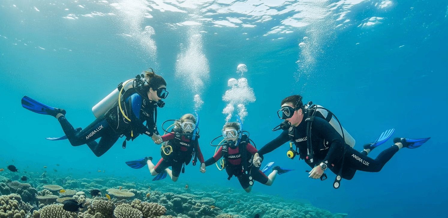 A family of divers holding hands over a coral reef